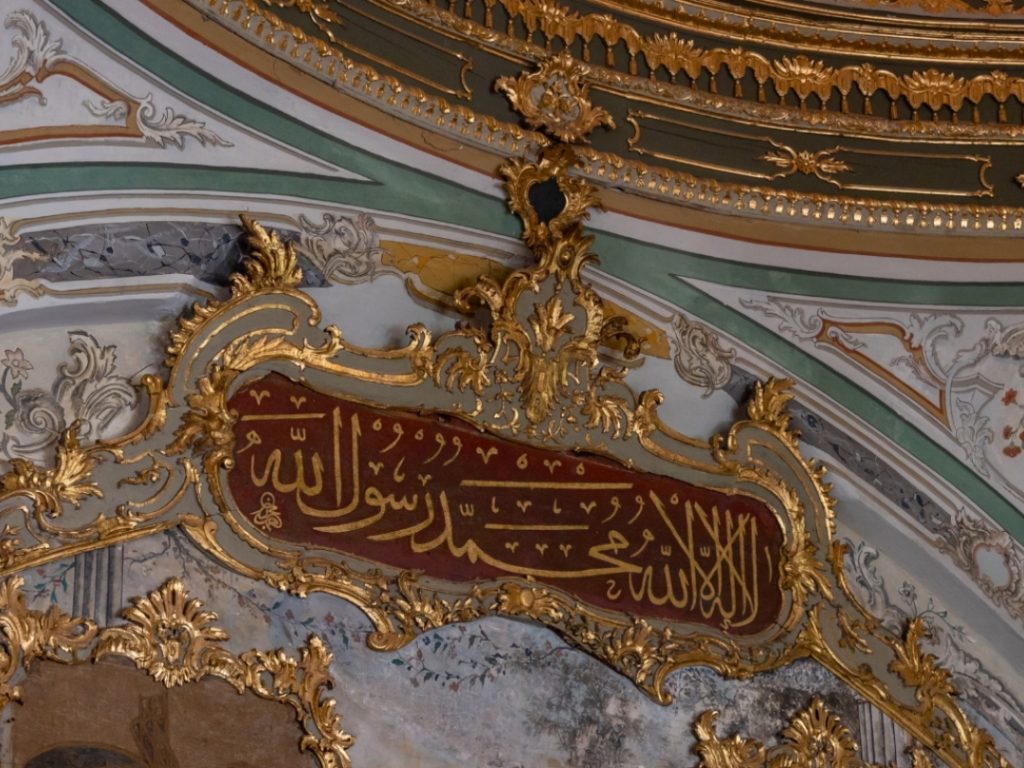 The ornate golden latticed window (Kafes-i Müşebbek) inside the Imperial Council hall, through which the Sultan secretly observed state meetings.