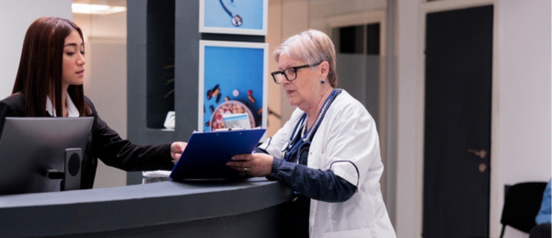 An international patient coordinator at a premier Turkish clinic meticulously planning a treatment schedule with a senior physician, ensuring a seamless and professionally managed healthcare journey.
