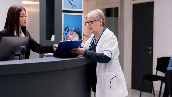 Super Medical An international patient coordinator at a premier Turkish clinic meticulously planning a treatment schedule with a senior physician, ensuring a seamless and professionally managed healthcare journey.