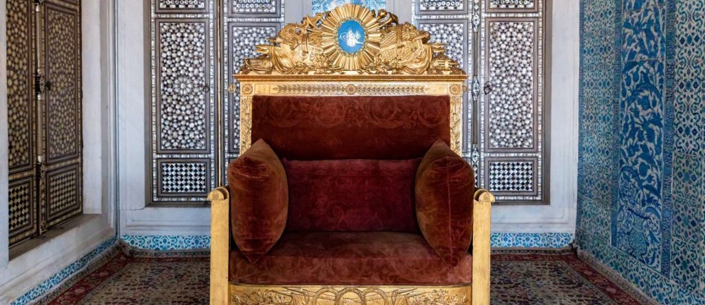 A close-up view of the a golden throne of dynasty, the centerpiece of the Topkapi Palace imperial treasury collection of imperial thrones.